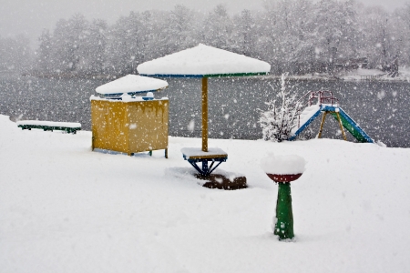 On the beach in the winter during a snowfallの写真素材