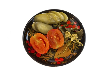 Pickled cucumbers and tomatoes on a plateの写真素材