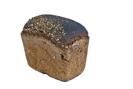 A loaf of rye bread, sprinkled with cumin, photographed close upの写真素材