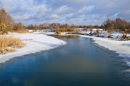 Winter landscape with frozen river with the wormwoodの写真素材