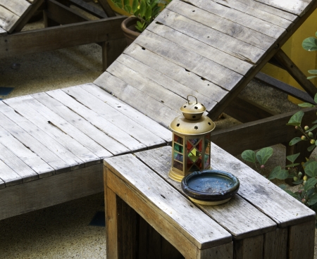 colorful lamp and Ashtray on wood table near swimming poolの写真素材