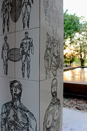 This sketch a man and a woman on a cement pillar. With the sun streaming through the trees, splashing on the water.の写真素材