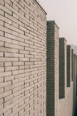 Close-up view of a brick wall with several columns, showcasing architectural details and textures.の素材