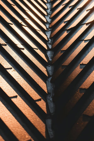 a close up of a metal roof with a light shining through itの素材