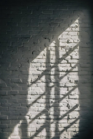 a white brick wall with a shadow of a personの素材