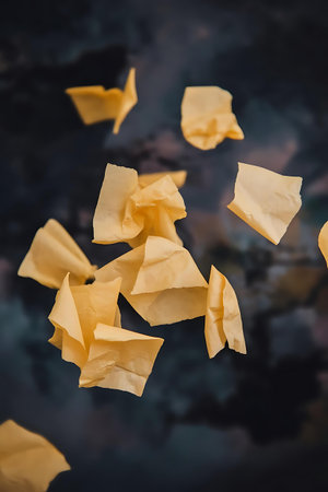 a bunch of yellow paper flying in the airの素材