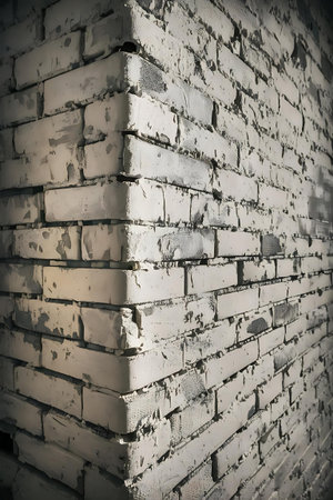 a brick wall with a white paint on itの素材