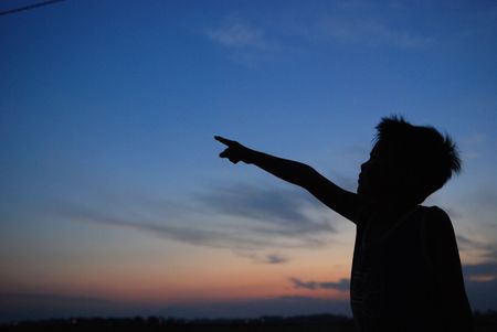 children, pointing, sunset, skies and clouds at the countryside の写真素材