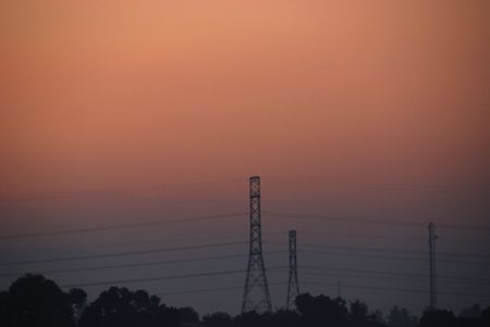 sunrise, electrical tower and skies at the countryside