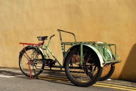 old tricycle at the back lane の写真素材