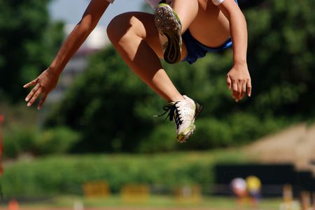 a man is flying - long jump