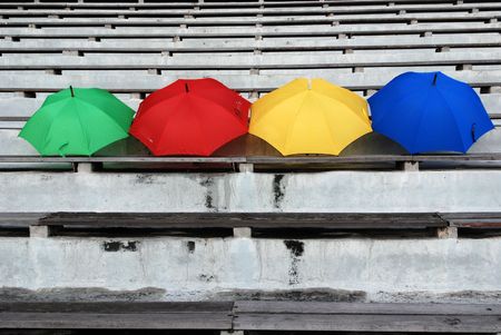 Colorful umbrellas on the stadium seats