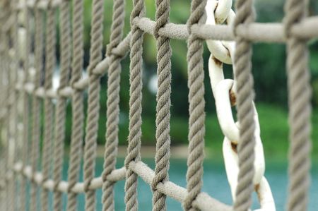 ropes of the suspension bridge at the seaside の写真素材