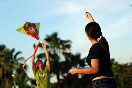 A girl flying a kite in the parks の写真素材