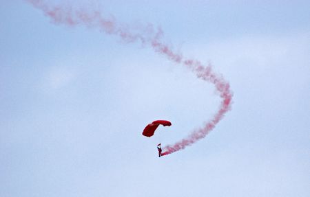 Parachuting and color smokes in the skies