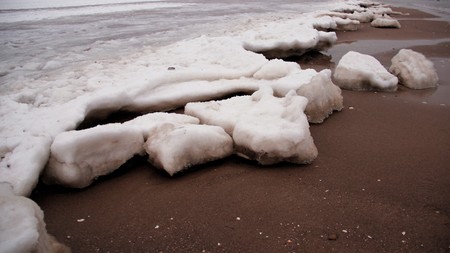 Cold winter ice on sandy beach. baltic seaside in Germanyの写真素材