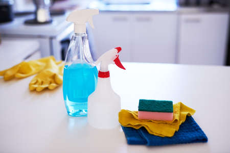 A still life of cleaning supplies on the kitchen counterの写真素材
