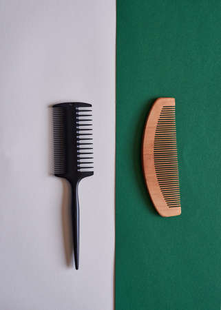 A comparison flat lay of plastic and wooden eco-friendly comb