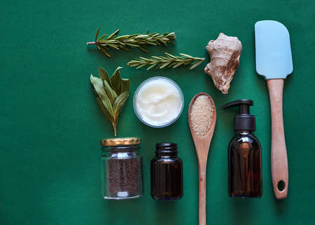 Homemade aromatherapy bath and spa products on a green background. Flat lay