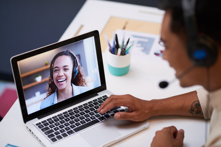 Close up of video screen with a conference call between two young people at workの写真素材