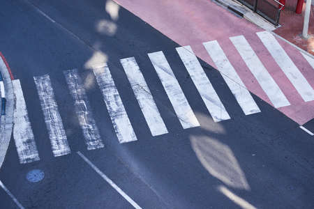 An overhead view of an empty pedestrian crossing in a cityの写真素材