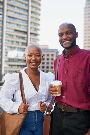 Two Black colleagues arrive at the office in the city for workの写真素材