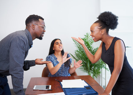Couple having an argument, fight, disagreement with mediator. Divorce lawyerの写真素材