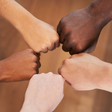 Circle of diverse hands, fists in circle, different skin colours unity teamworkの写真素材