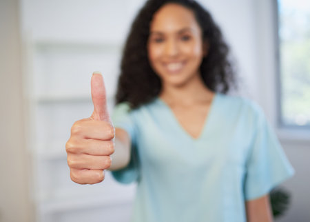 Selective focus on thumb as healthcare professional gives thumbs upの写真素材