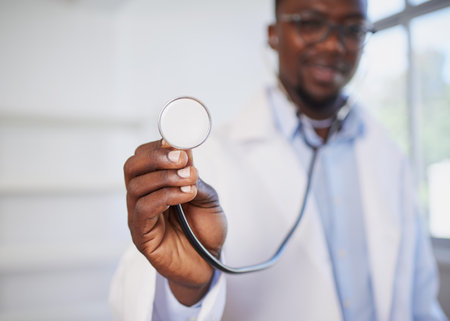 Close up of doctors stethoscope with smiling male doctor in backgroundの写真素材