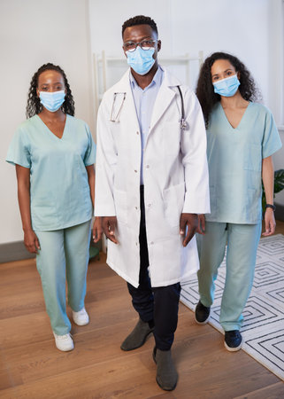 Portrait of surgical team wearing masks, doctor and nurses in a rowの写真素材