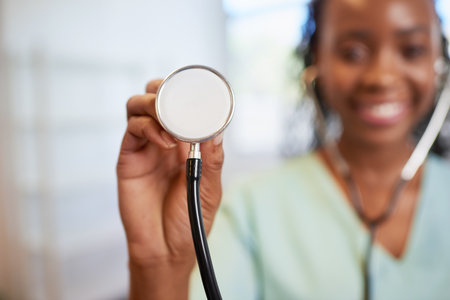 Close up of doctors stethoscope with smiling female doctor in backgroundの写真素材