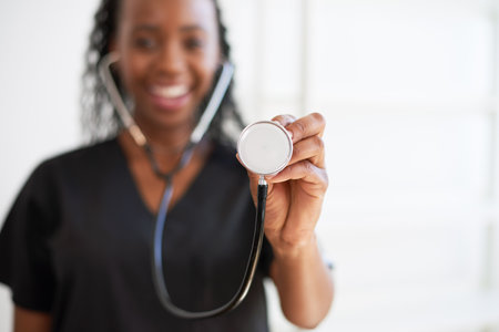 Close up of doctors stethoscope with smiling female doctor in backgroundの写真素材