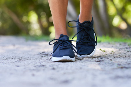 Close up of running shoes in park, woman running fitness outdoors
