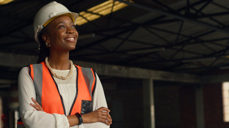 Confident Female Engineer at Construction Site Wearing Safety Gear