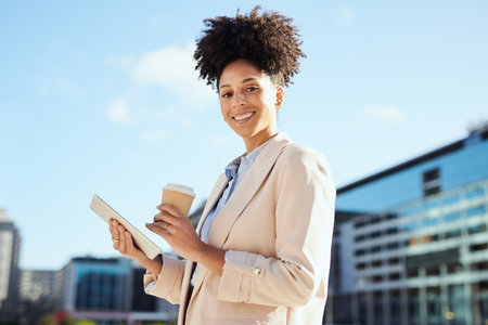 Confident Businesswoman with Tablet and Coffee in the Cityの写真素材