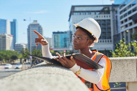 Confident Female Engineer Planning Urban Construction Projectの写真素材