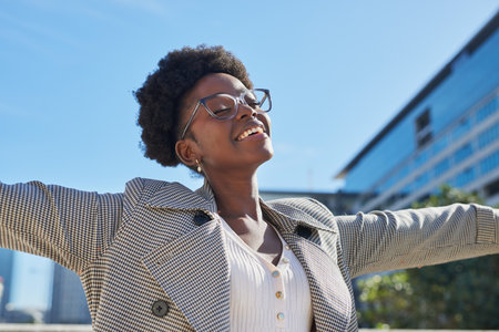Joyful Woman Enjoying Sunlight in Urban Settingの写真素材