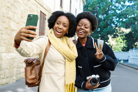 Joyful Friends Taking a Selfie Outdoors on a Sunny Day in the City