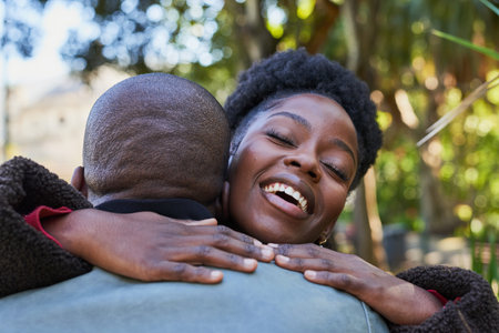 Joyful Embrace of a Couple in the Vibrant Outdoors on a Sunny Dayの写真素材