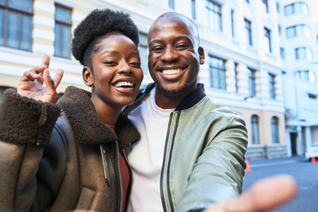 Smiling Couple Taking a Fun Selfie in the Heart of the City on a Vibrant Day