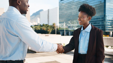 Professional Business Handshake Outdoors in a Modern Urban Settingの写真素材
