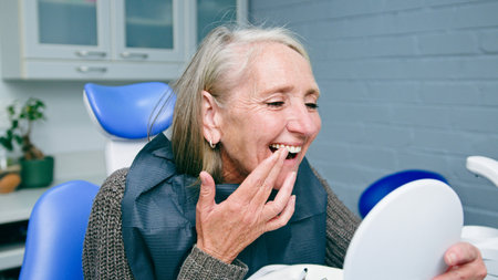 Smiling Senior Woman Admiring Her Teeth During a Visit to the Dentist
