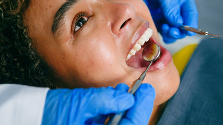 Patient Undergoing a Dental Checkup With Dentist Using Medical Tools and Gloved Hands