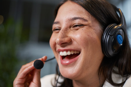 Smiling Customer Service Representative Engaging with a Client Using a Headsetの写真素材