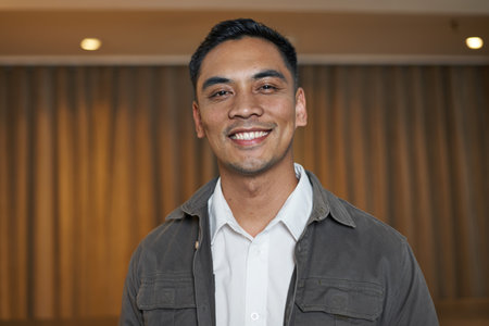 Smiling Individual Posing in a Modern Hotel Lobbyの写真素材