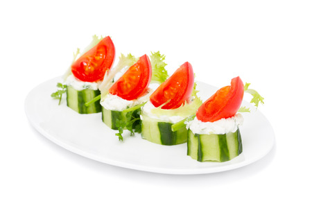 Cucumber Bites with Cream Herb  Cheese and Cherry Tomatoes isolated on white