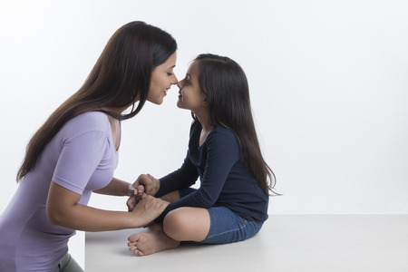 Mother and daughter rubbing nosesの写真素材