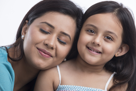Close up of mother leaning on daughter shoulderの写真素材