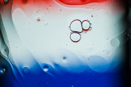 Oil drops on the water の写真素材